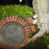 After the main components were in place I found I still had a gap between the door frame and the tree. The picture shows the solution, some brickwork and moss in behind the warty lumps on the trunk to fill the gap.